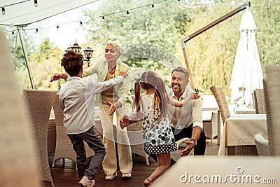 Loving grandparents meeting and hugging their grandchildren Stock Photo