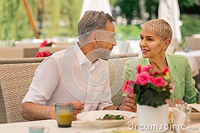 Loving grey-haired mature man looking at his beautiful wife Stock Photo