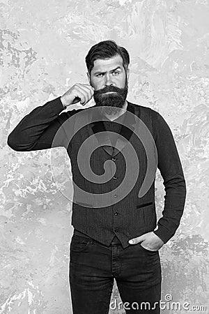 Loving his style. brutal man touch mustache. Perceptions of male beauty. Bearded hipster with shaved temples. Vintage Stock Photo