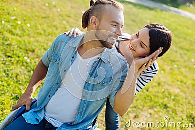 Loving husband in wheelchair stroking his wifes cheek Stock Photo