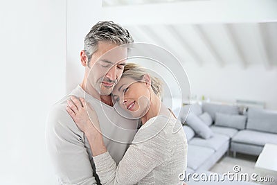 Loving mature couple embracing at home Stock Photo