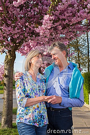 Loving middle-aged couple in a spring street. Stock Photo