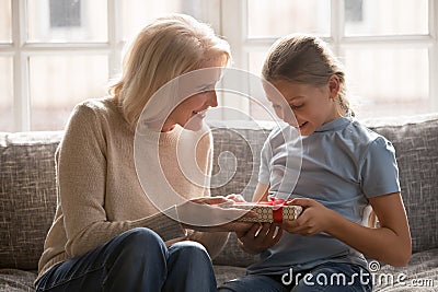 Caring senior grandmother congratulate granddaughter with birthday Stock Photo