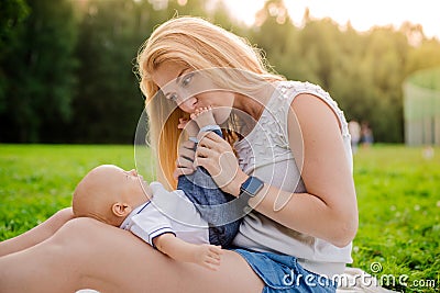 Loving mother with her newborn baby on her arms. Stock Photo