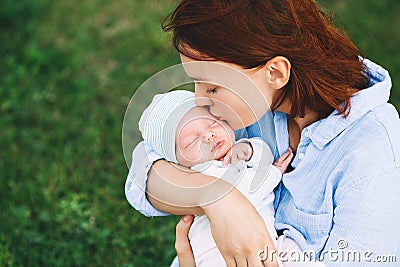 Loving mother with her newborn baby on her arms. Stock Photo