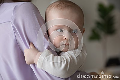 Loving mother lulls in arms her cute baby, closeup Stock Photo