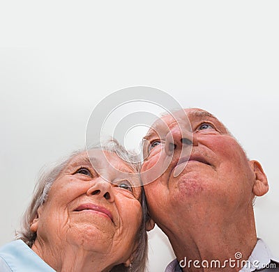 Loving older couple looking up with a smile Stock Photo
