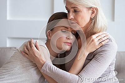 Loving senior mother hug adult daughter showing support Stock Photo