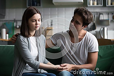 Loving understanding boyfriend comforting consoling sad girlfrie Stock Photo