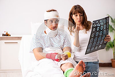 The loving wife looking after injured husband Stock Photo