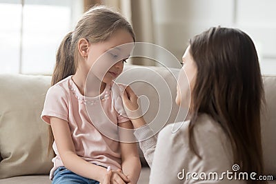 Loving mom talking to upset little child girl giving support Stock Photo