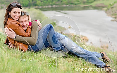 Loving young couple embracing on a hill top Stock Photo