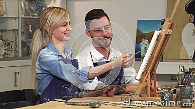 Loving young couple enjoying working on a painting at the Art Studio together Stock Photo