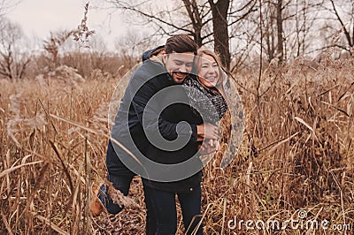 Loving young couple happy together outdoor on cozy warm walk in autumn forest Stock Photo