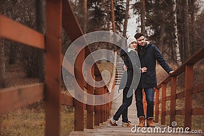 Loving young couple happy together outdoor on cozy warm walk in forest Stock Photo