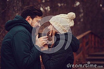 Loving young couple happy together outdoor, drinking tea from thermos, autumn camp Stock Photo