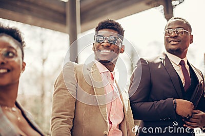 Low angle cropped view of guys with positive smiles watching the ceremony Stock Photo