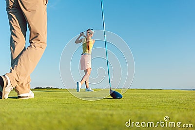 Female professional golfer hitting a long shot during a challenging game Stock Photo