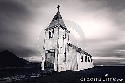 Low angle grayscale shot of the Hellnar Church in a field in Iceland on a cloudy day Stock Photo