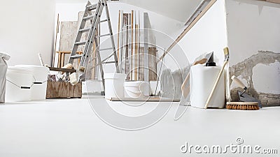 Low angle of indoor shot of construction or building site of home renovation with tools on white floor with paint buckets and Stock Photo