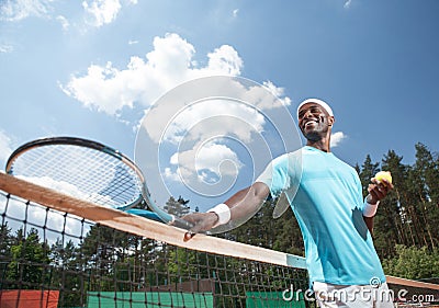 Jolly man is enjoying tennis match in open air Stock Photo