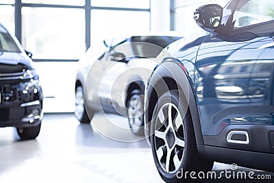 Low angle of luxurious car in a exclusive showroom with vehicles Stock Photo