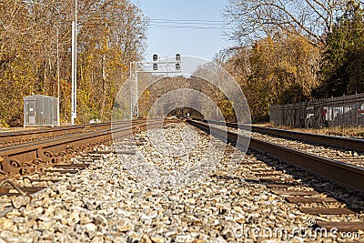 Low angle nostalgic image of two railroad tracks going into the woods. Stock Photo