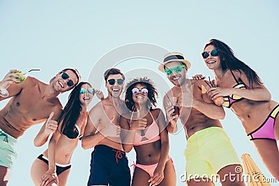 Low angle photo of charming bachelors enjoying holding glass juice laughing wearing eyeglasses eyewear standing outdoors Stock Photo