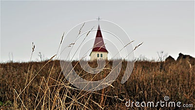 Low angle shot of dome of Hellnar Church in field of south coast of Snaefellsnes peninsula Iceland. Stock Photo