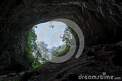 Low angle shot of the exit of a dark cave in Skrad, Croatia Stock Photo