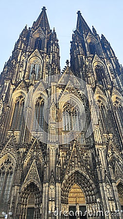 Low angle shot of a historic Cologne Cathedral exterior wall architectural patterns under clear sky Stock Photo