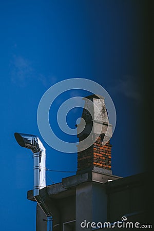 Low angle shot of an old building chimney under the evening sky Stock Photo