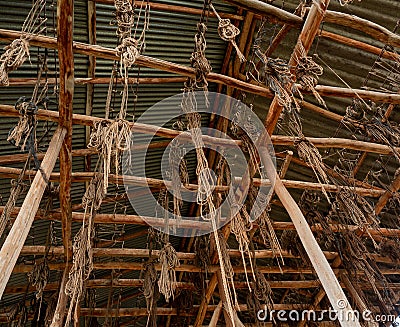 Low angle shot of ropes tangled on wooden columns Stock Photo