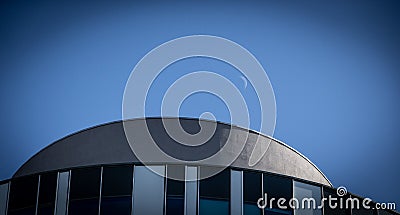 Low angle shot of a round shape building on blue sky background Stock Photo