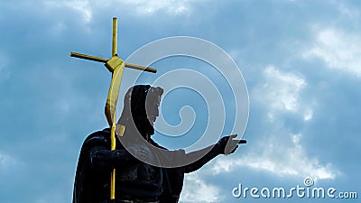 Low-angle shot of the Statue of John the Baptist against the cloudy sky in Prague, Czech Republic Stock Photo