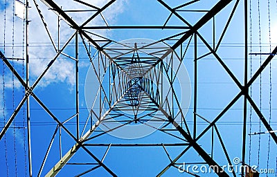 Low-angle shot of a steel electricity pylon on a blue sky background Stock Photo