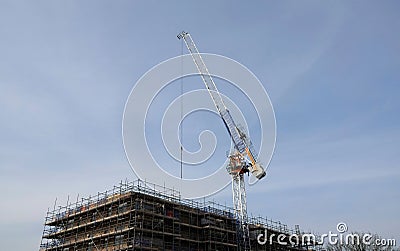 Low angle shot of a tower crane above a construction site in Billericay, Essex, UK Stock Photo