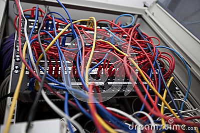 Low angle of tangled wires in server room at television station Stock Photo