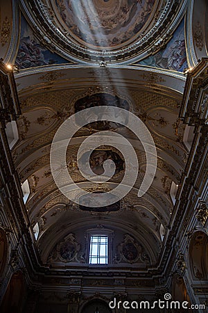 Low-angle vertical shot of the ceiling of Church in Milan with sunlight Editorial Stock Photo