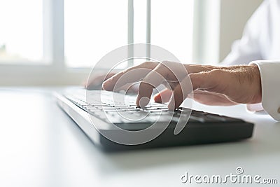 Low angle view of business programmer using computer keyboard Stock Photo