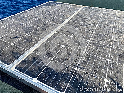 Low angle view and close-up of dusty solar panel Stock Photo