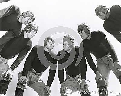 Low angle view of football huddle Stock Photo