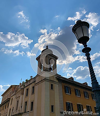 View form The Pons Fabricius of sun shining behind clouds at sunset over Tiber Island in Rome, Italy Stock Photo