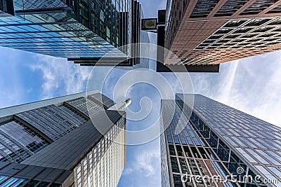 low angle view of four skyscrapers with different facade designs under the blue sky Stock Photo