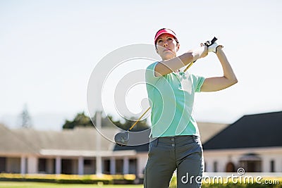 Low angle view of golfer woman taking shot Stock Photo