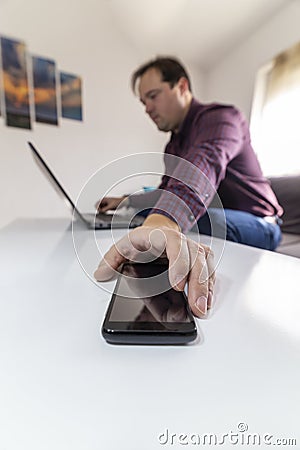 Man getting a call and taking his mobile phone Stock Photo