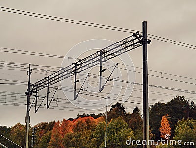 Low angle view power cables over train tracks Stock Photo