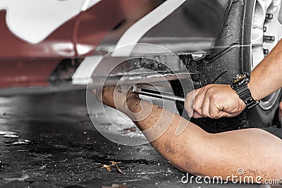 Low angle view of profession mechanic repairing car in automobile shop Stock Photo