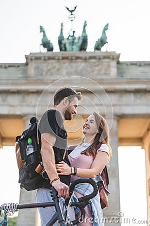 low angle view of smiling female traveler embracing boyfriend Stock Photo