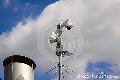 Low angle view on surveillance cameras against blue sky and clouds in city center of Venlo Stock Photo